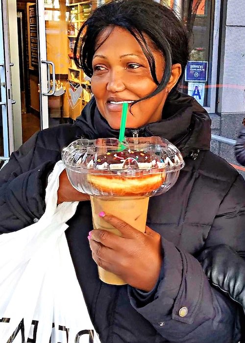 girl with GoLidZ lid on Starbucks cup